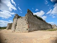 a stone wall with a blue sky